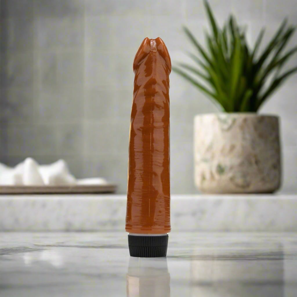 Brown cylindrical vibrator with a black base on a white background