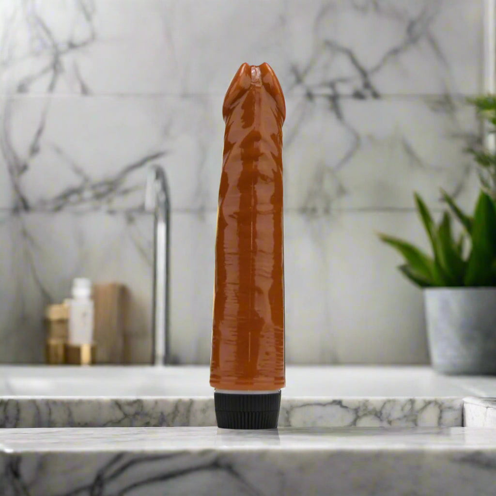 Brown cylindrical vibrator with black base on a white background