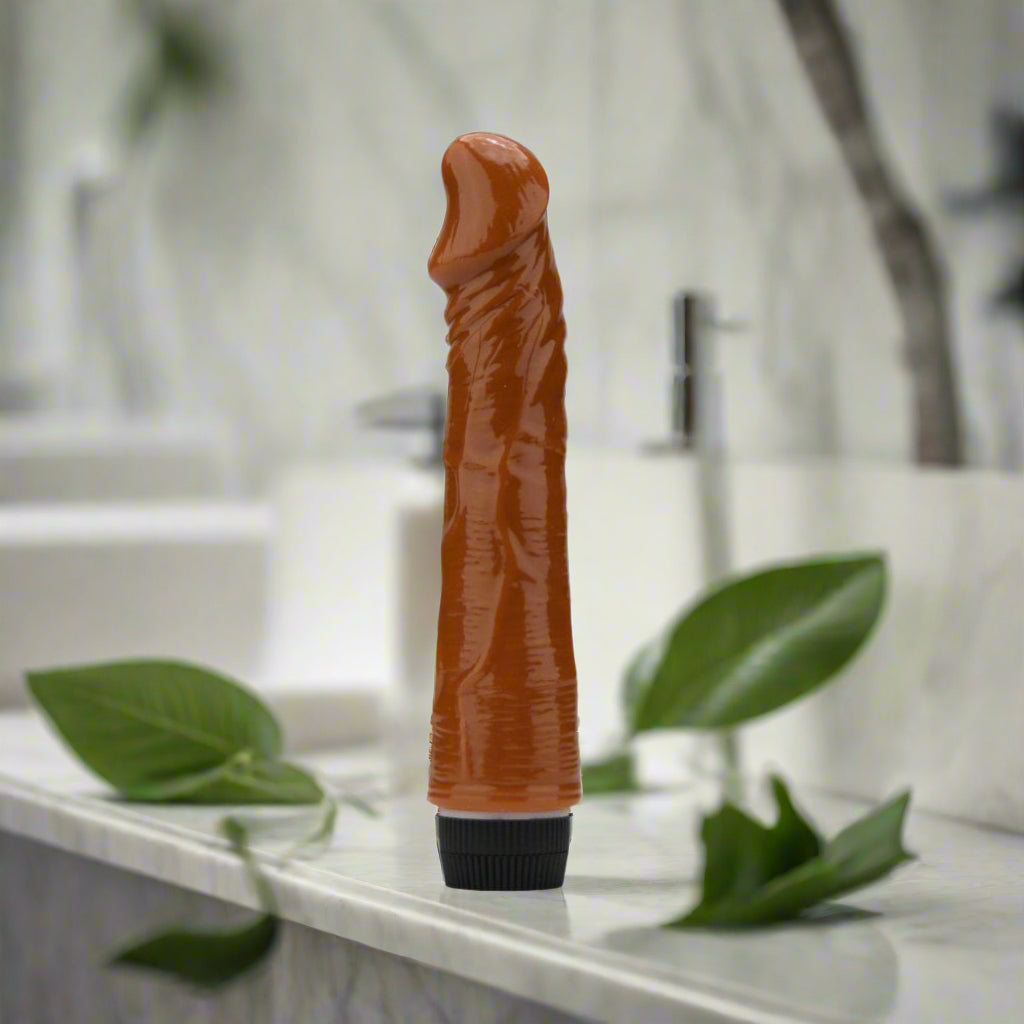Brown cylindrical vibrator with a black base on a white background