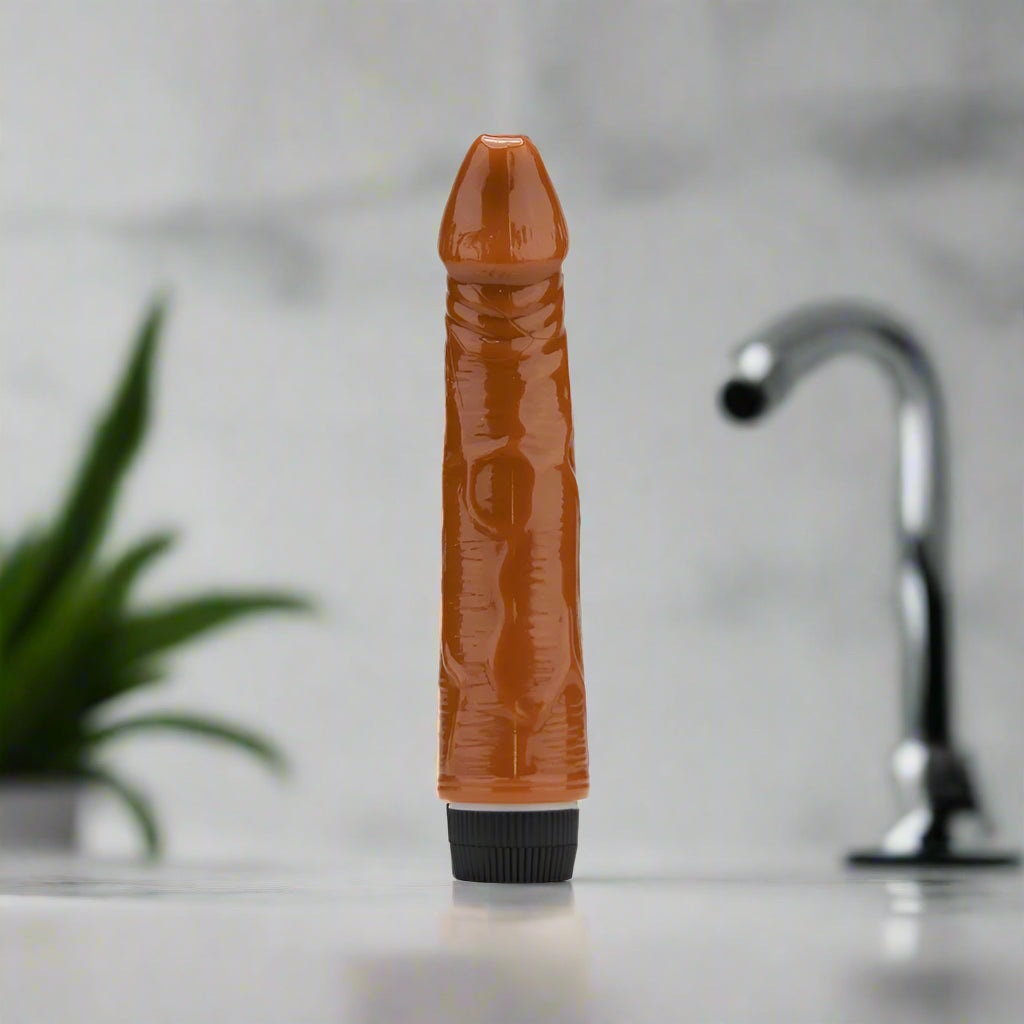 Brown textured vibrator with a black base on a white background