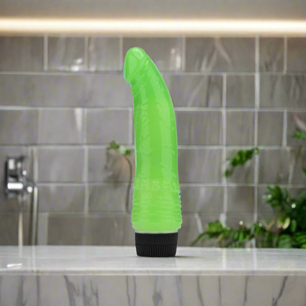 Green and black vibrator on a white background