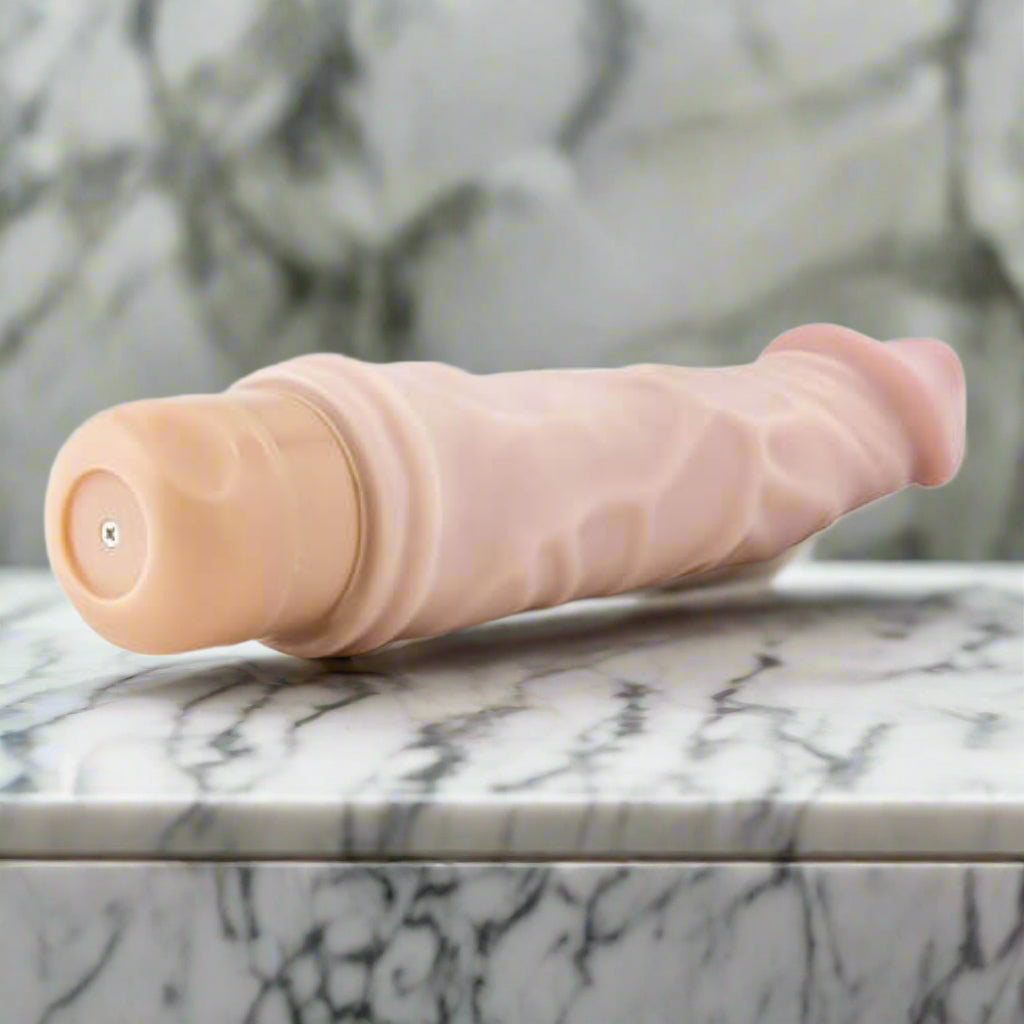 Beige vibrator on a white background