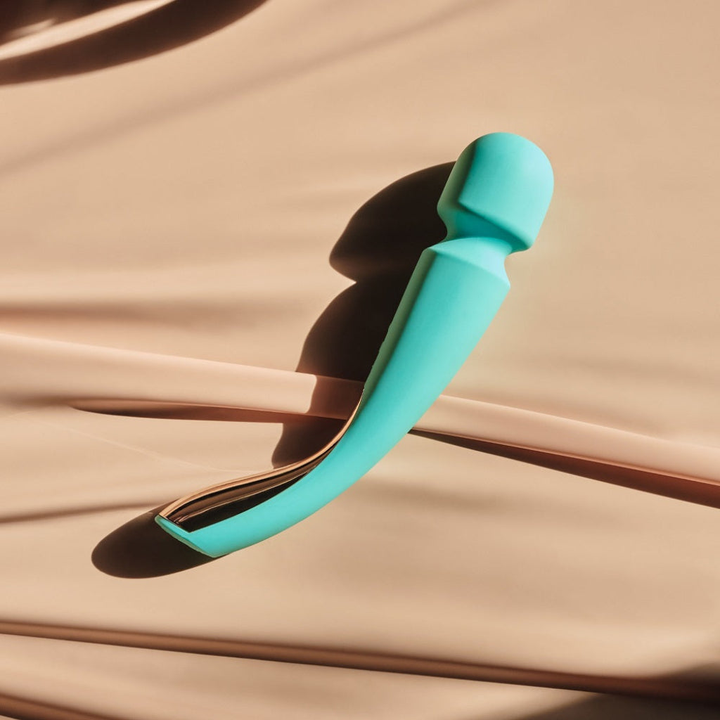 Turquoise wand vibrator on a beige fabric background