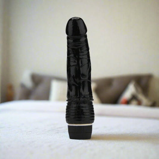 Black textured vibrator on a white background