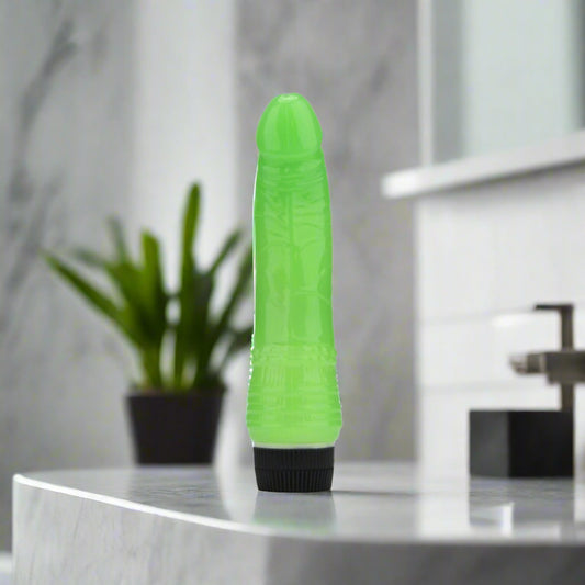 Green and black vibrator on a white background