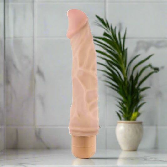 Beige silicone vibrator on a white background