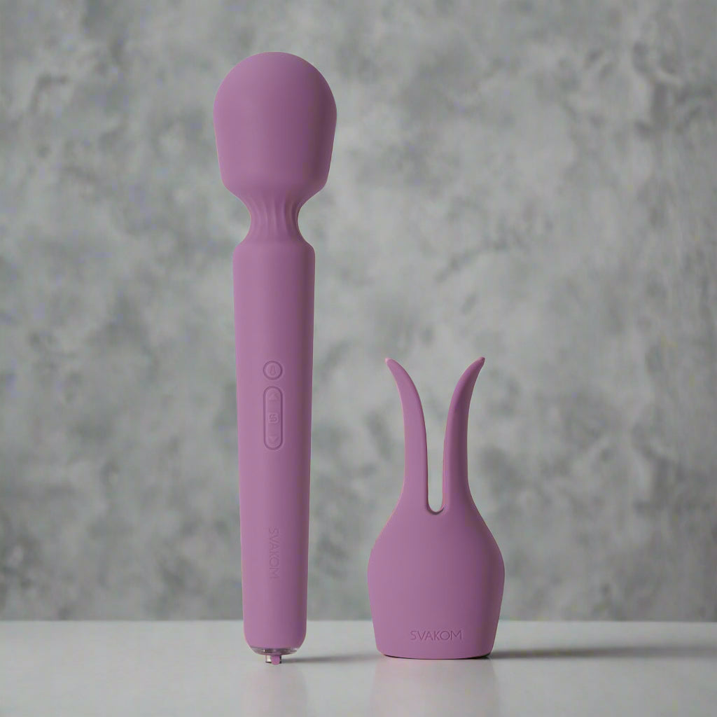 Purple wand vibrator with a handle and detachable nozzle on a white background