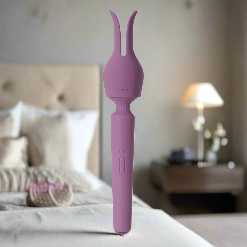 Purple wand vibrator on a white background