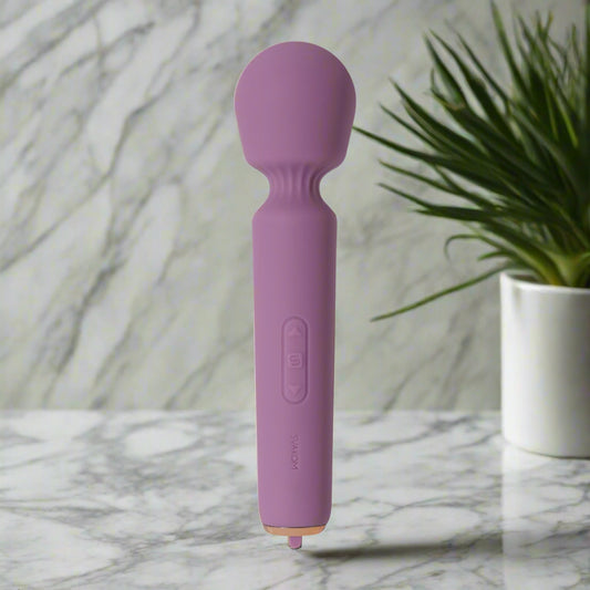Purple handheld massager on a white background