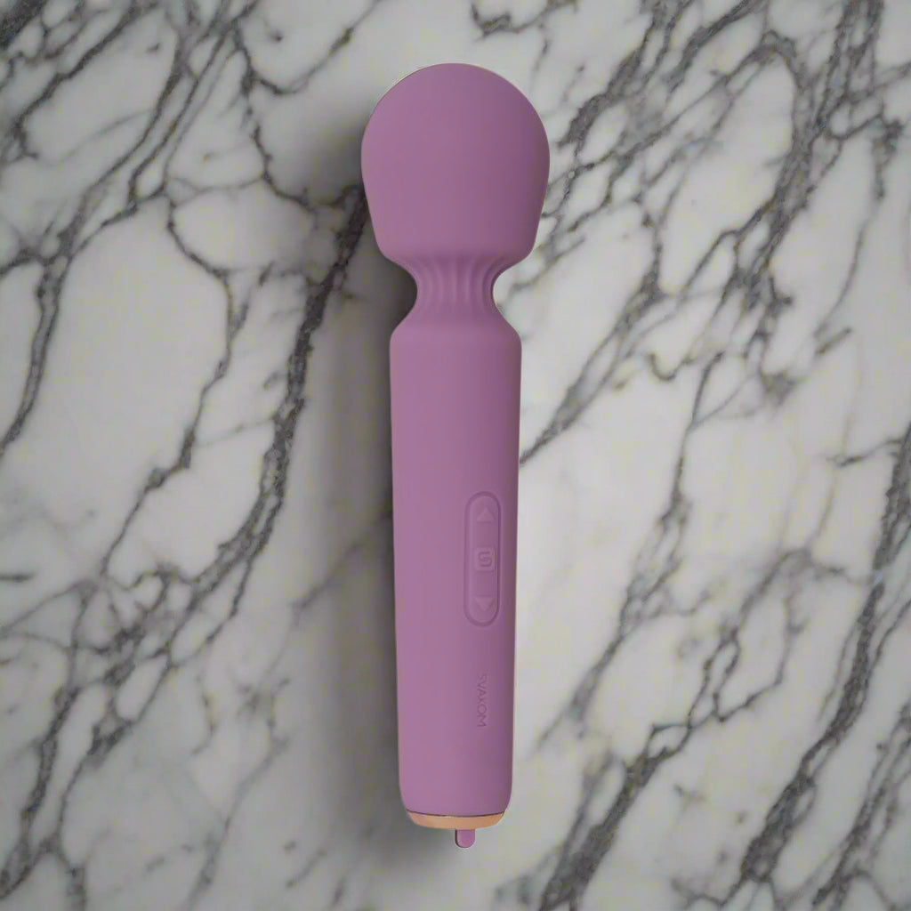 Purple handheld massager on a white background