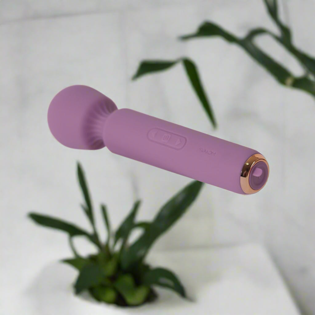Purple wand vibrator with gold accent on a white background