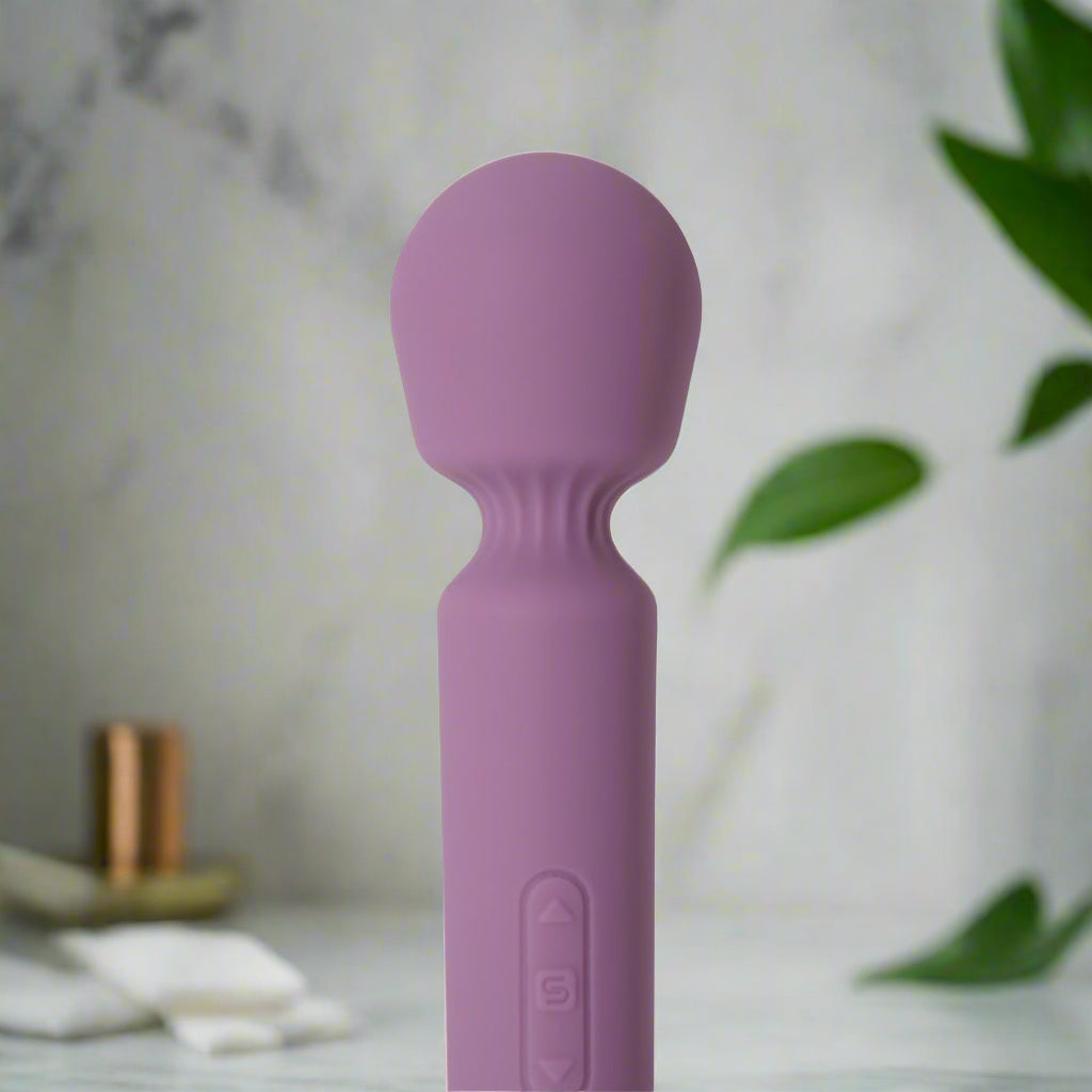 Purple handheld massager on a white background