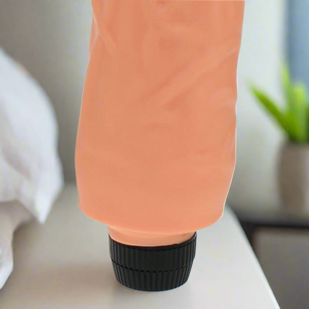 Close-up of a peach-coloured vibrator on a white background